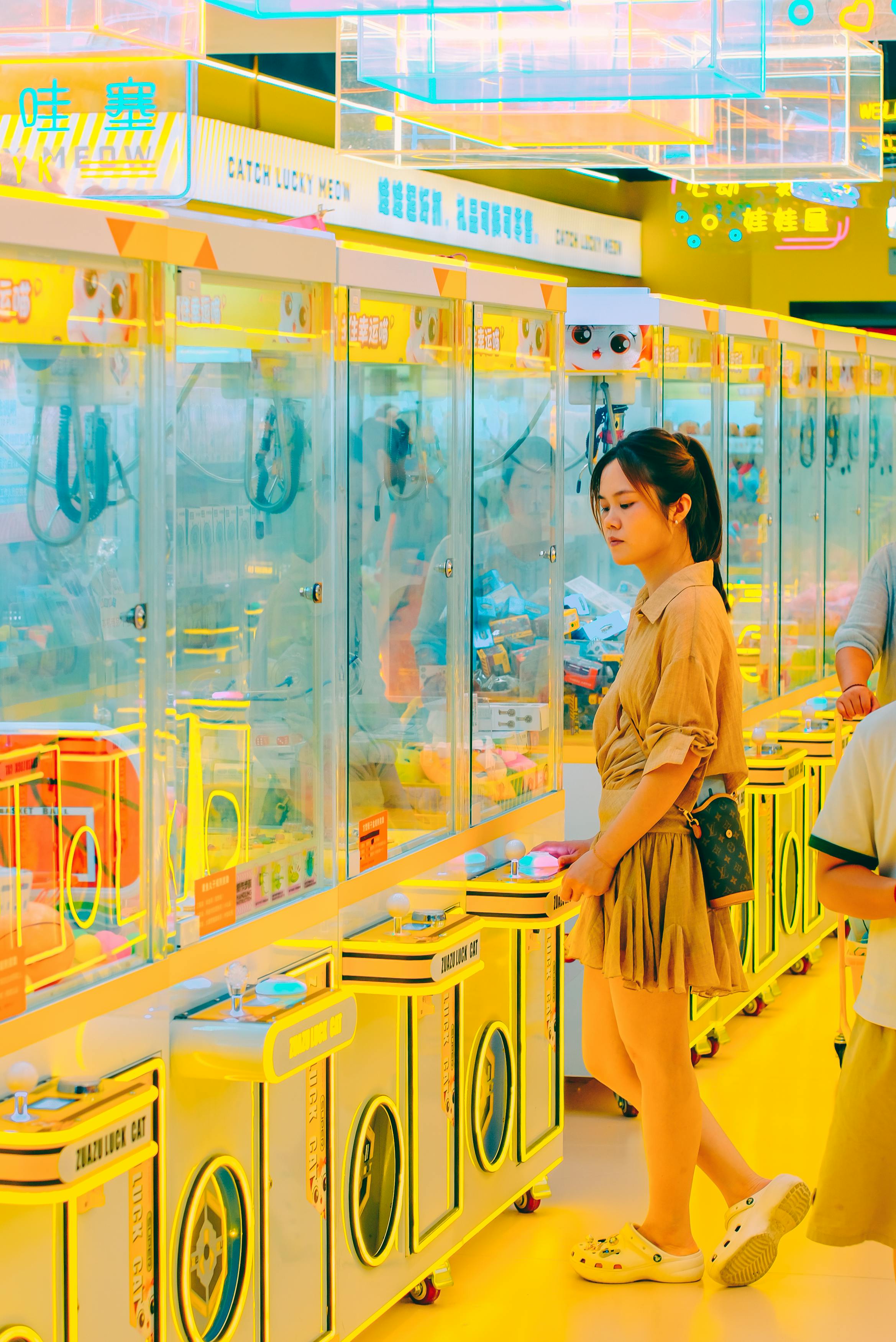 Woman browsing claw machine row